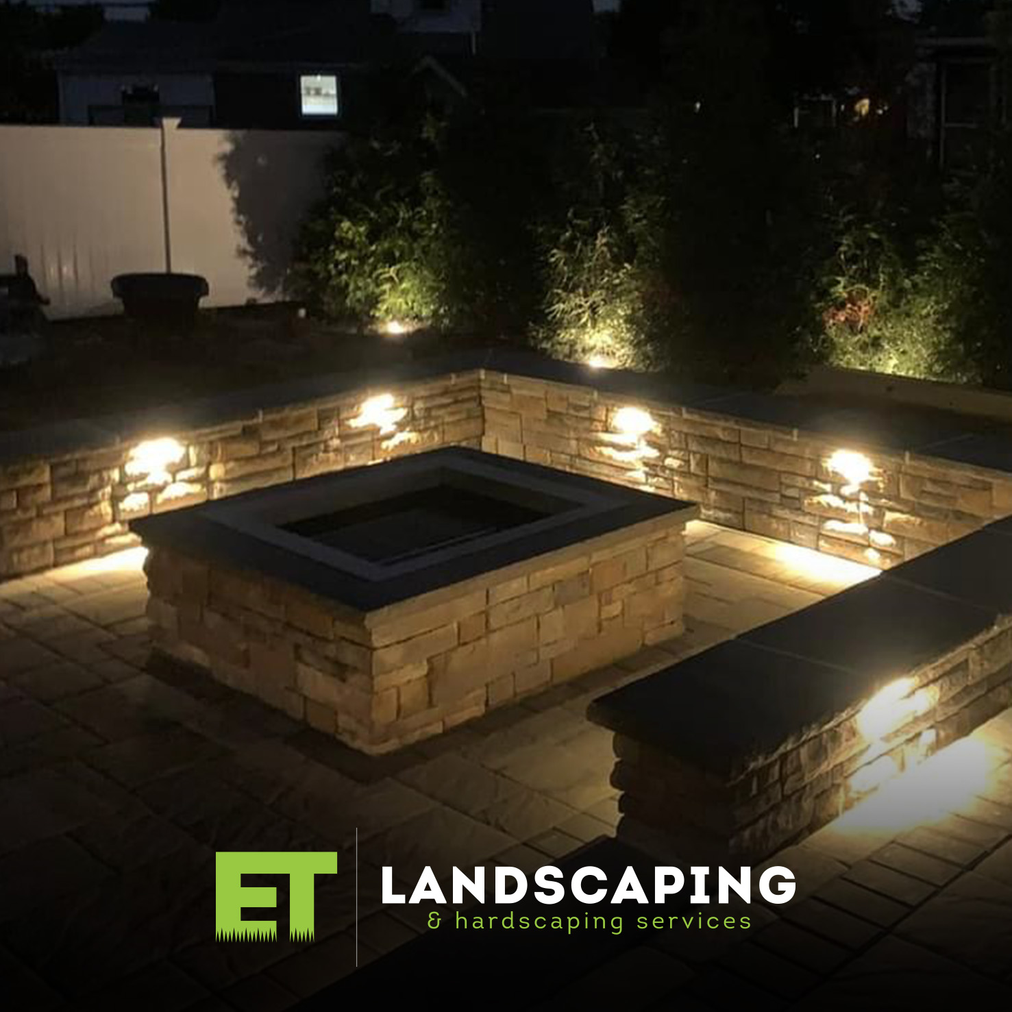 ET Landscaping Project - illuminated-stone-fire-pit-area-night